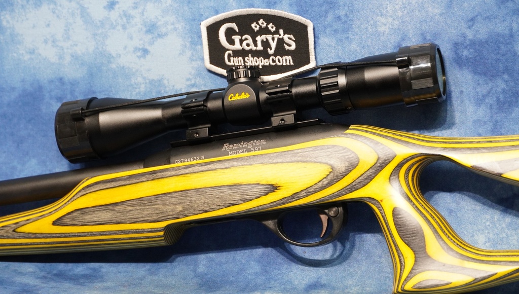 USED REMINGTON 597 22 LR 20" HVY BBL LAMINATE STOCK W/SCOPE